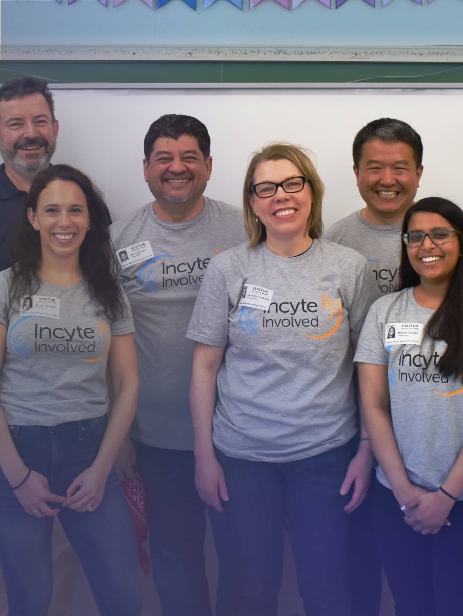 Large group of people standing in front of a chalkboard