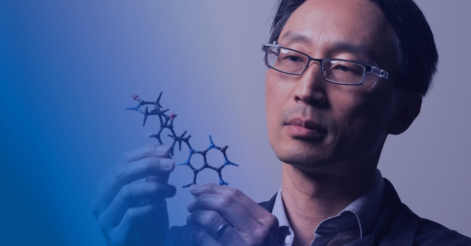 Scientist looking at a molecule model